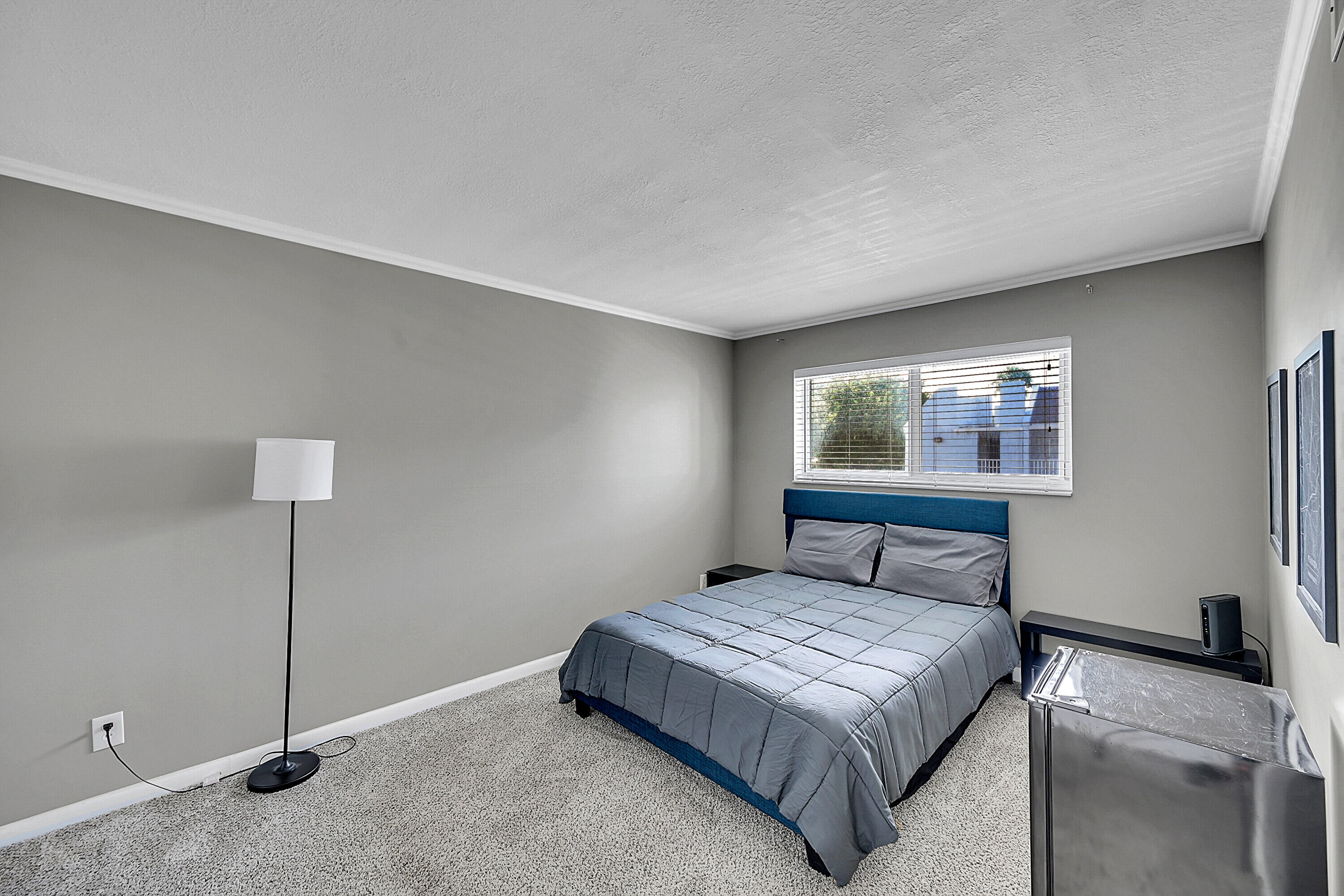 2920 Southwest 22nd Avenue, Unit 6040 Delray Beach, FL 33445 - Photo 44 of 53 a bedroom with a bed and a night stand