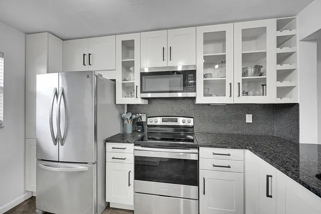 a sign of golf club on a wall under a large tree