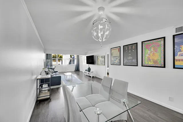a dining room with furniture and wooden floor