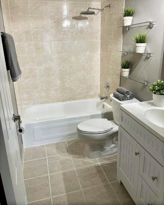 2920 Southwest 22nd Avenue, Unit 6040 Delray Beach, FL 33445 - Photo 8 of 53 a bathroom with a granite countertop toilet a sink and a bathtub