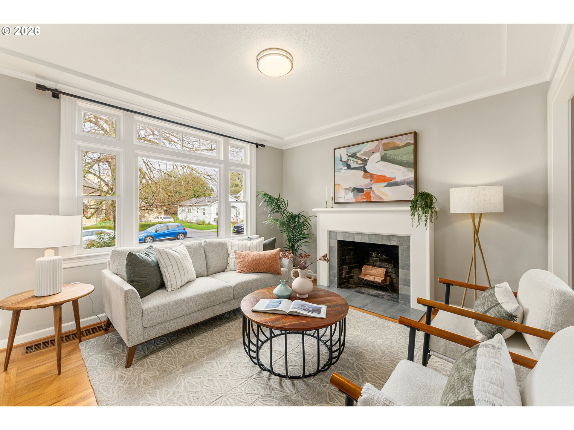2624 Southeast Kelly Street Portland, OR 97202 - Photo 5 of 36 a living room with furniture a fireplace and a large window