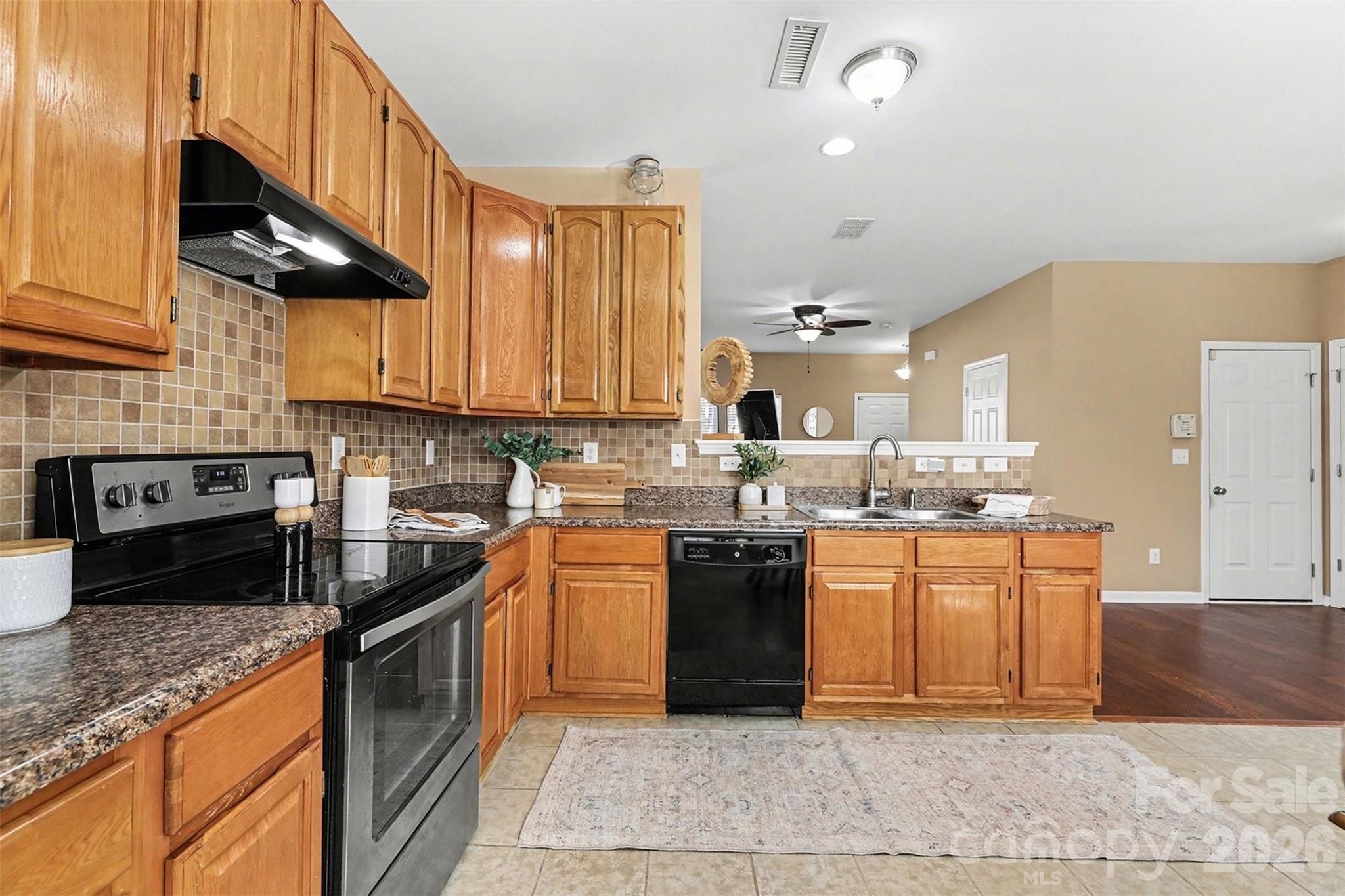 1806 Tradd Avenue Clover, SC 29710 - Photo 10 of 29 a kitchen with stainless steel appliances granite countertop a stove a sink dishwasher and a microwave oven with large cabinets