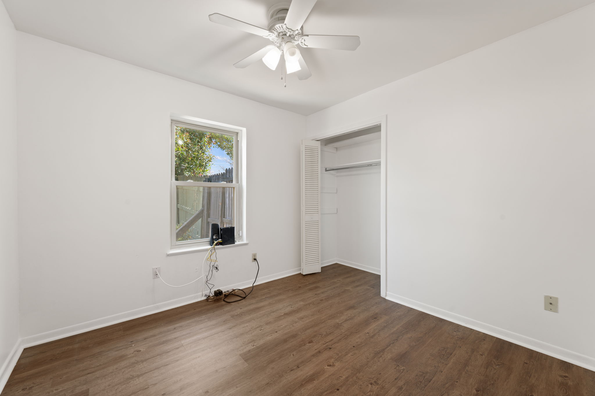 1400 Summit Circle Taylor, TX 76574 - Photo 22 of 39 wooden floor in an empty room with a window