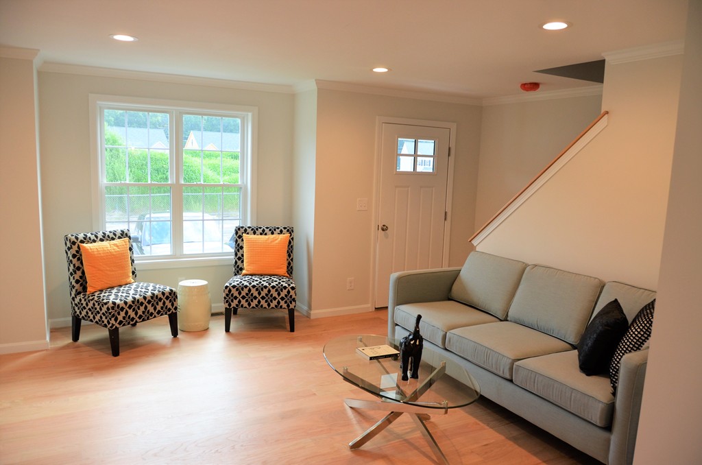 93 Riley Road, Unit 119 Tyngsborough, MA 01879 - Photo 7 of 14 a living room with furniture and a large window