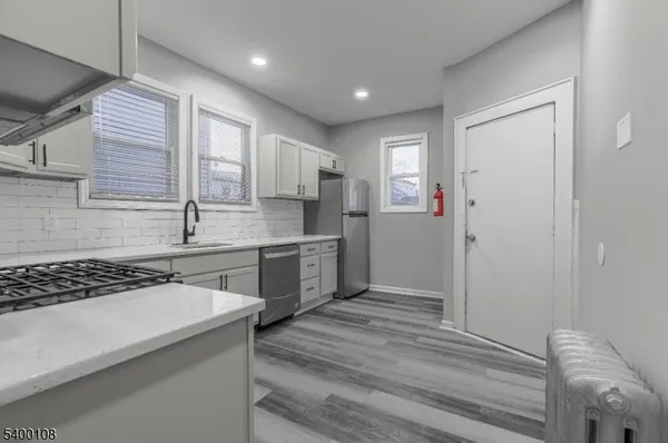 a kitchen with a refrigerator and a sink