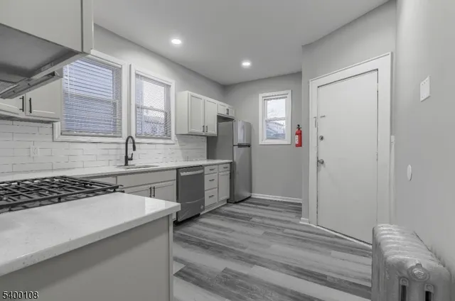 a kitchen with a refrigerator and a sink