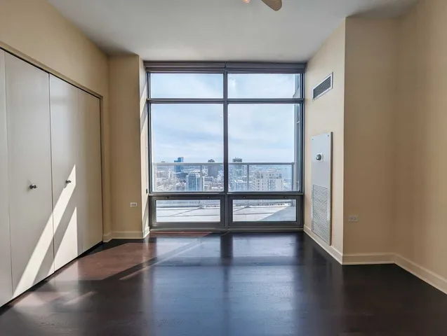 an empty room with wooden floor and sliding door