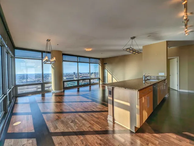 a open kitchen with stainless steel appliances kitchen island granite countertop a refrigerator and stove