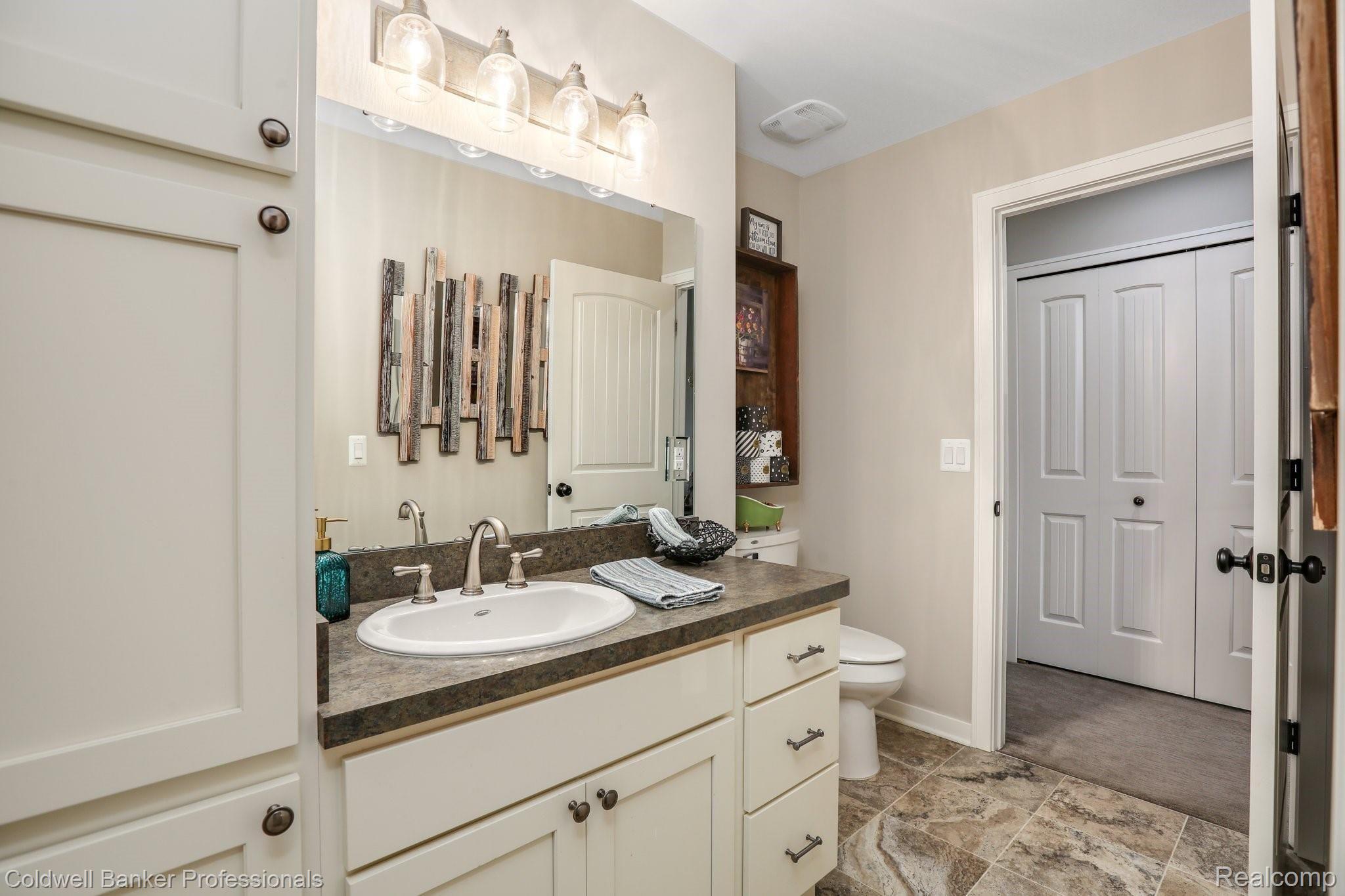 8665 Oakhill Road Clarkston, MI 48348 - Photo 27 of 49 Toilets and sink featured separately from the full shower to allow everyone their own space.