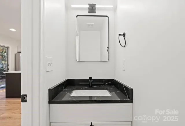 a bathroom with a sink and mirror