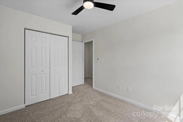 a bathroom with a toilet sink vanity and mirror