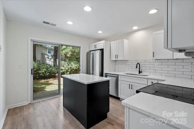 a kitchen that has a sink and a stove in it