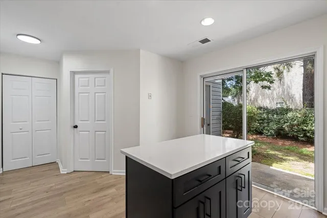 a kitchen that has a sink and a wooden floor