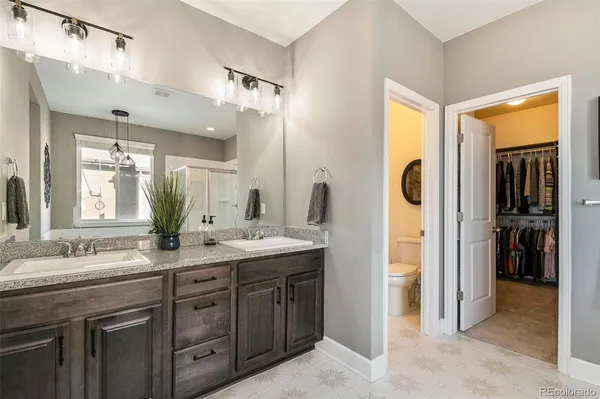 a spacious bathroom with a tub shower and windows