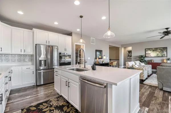 a kitchen with stainless steel appliances kitchen island a refrigerator and a stove