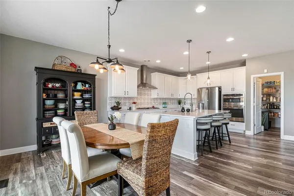 a living room with furniture and kitchen view