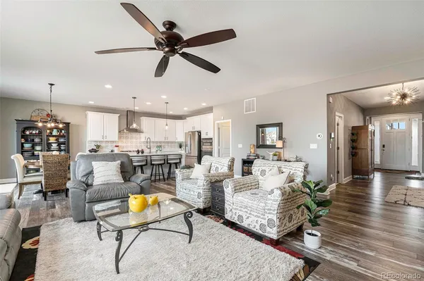 a living room with furniture fireplace and kitchen view