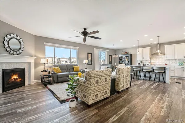 a living room with furniture a fireplace and window