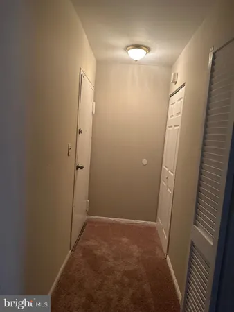 a view of hallway with a mirror