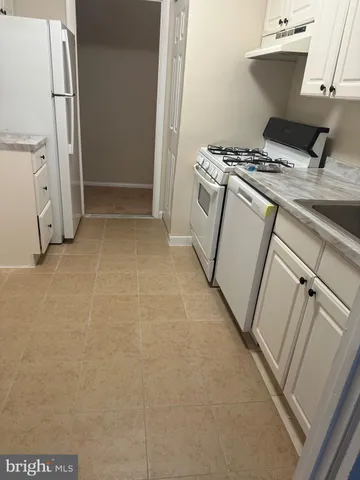 a kitchen with a stove and a refrigerator