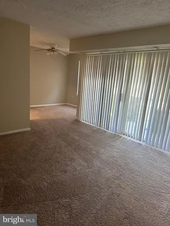 a view of a room with wooden floor and windows