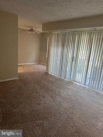 a view of a room with wooden floor and windows