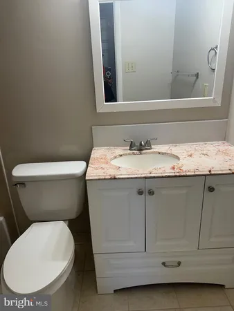 a white toilet sitting next to a bathroom sink