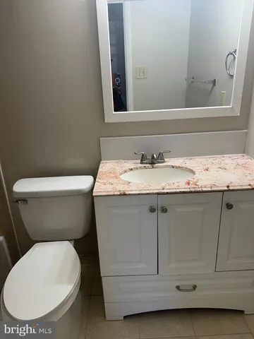 a white toilet sitting next to a bathroom sink