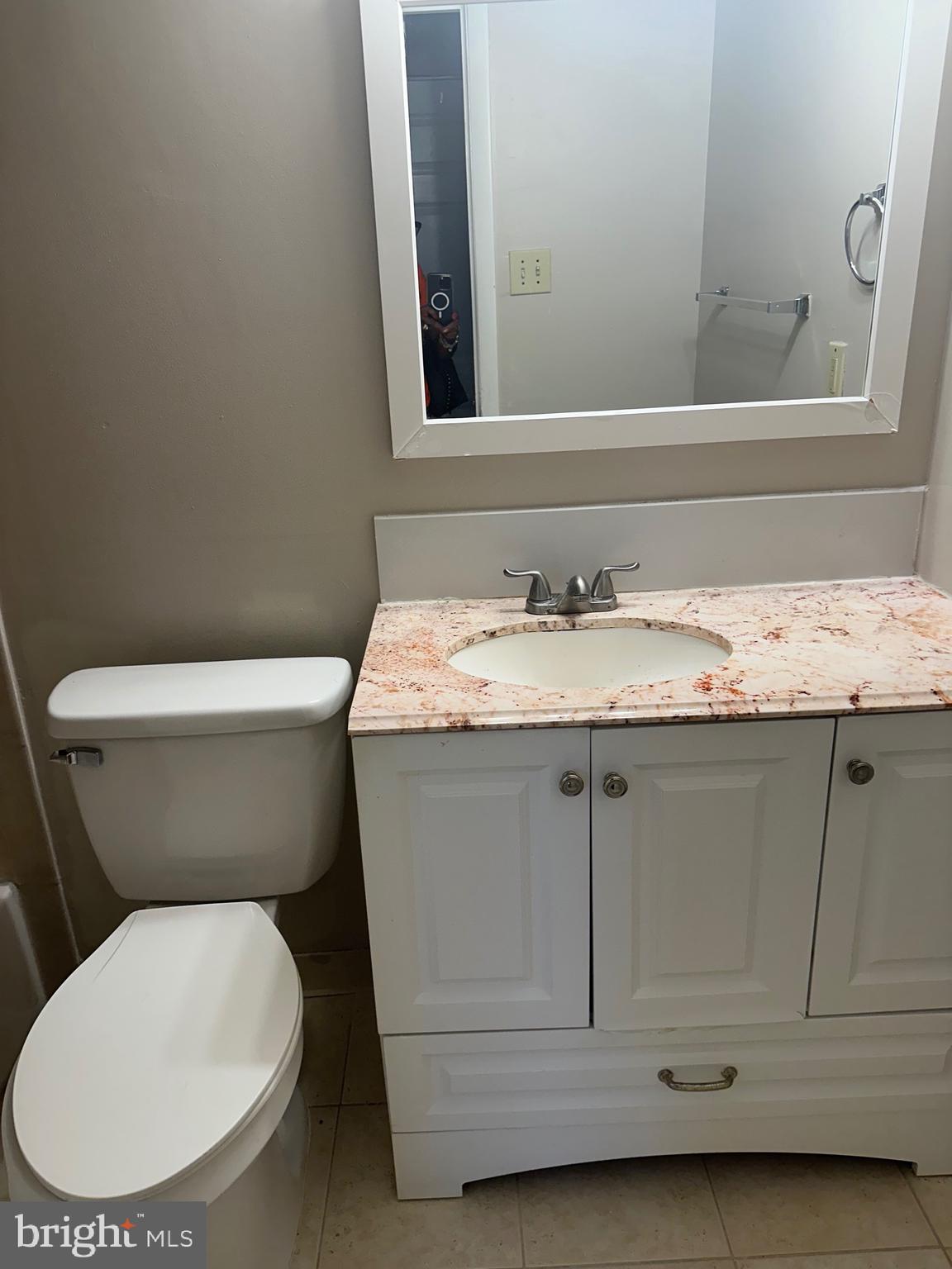 3837 St Barnabas Road, Unit 103 Suitland, MD 20746 - Photo 9 of 10 a white toilet sitting next to a bathroom sink