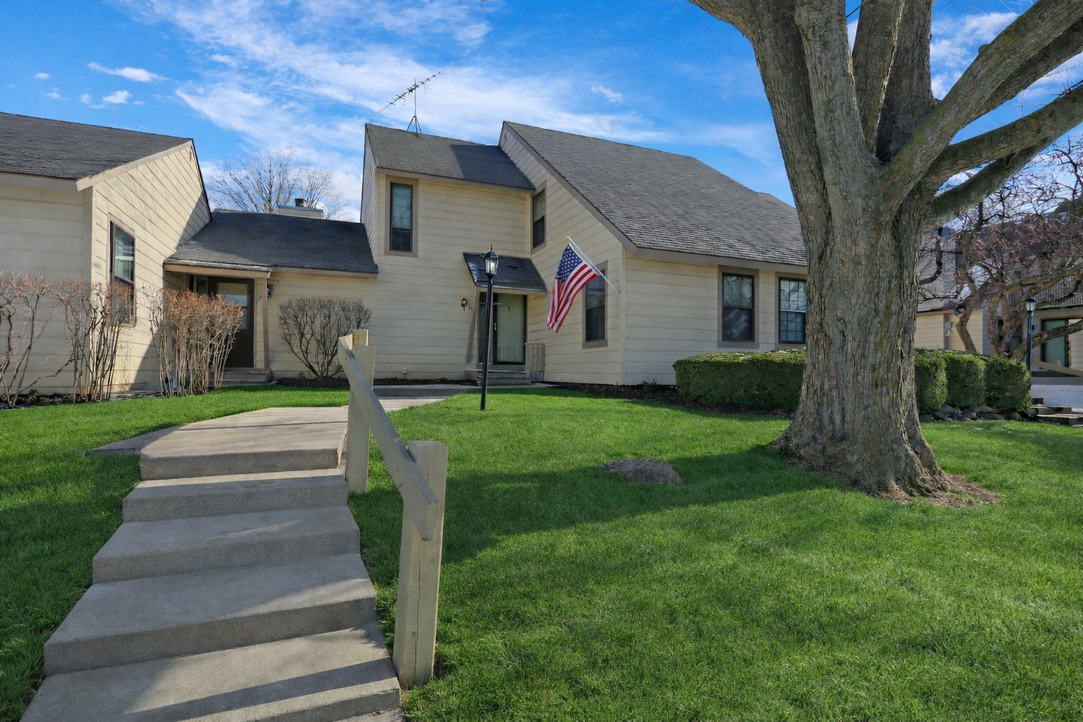 a front view of house with yard and green space
