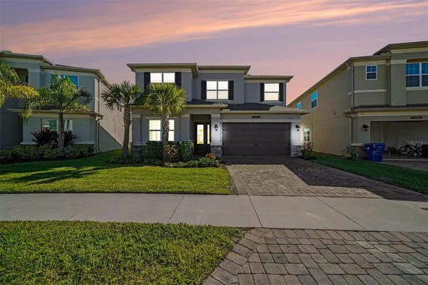 a front view of a house with a yard and garage