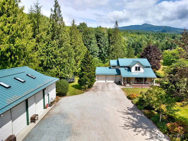 an aerial view of a house with a yard