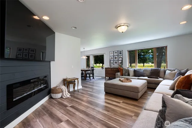 a living room with furniture flat screen tv and a fireplace