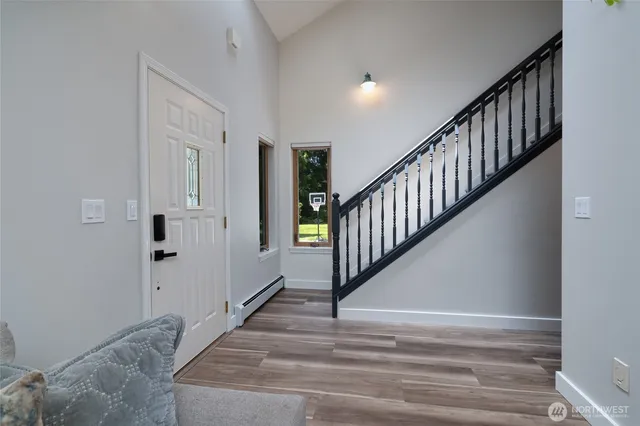 a view of staircase with white walls and white door
