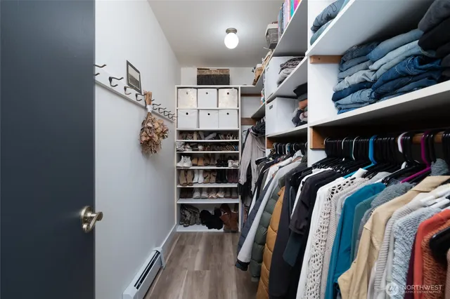 a view of walk in closet with clothes and shoes