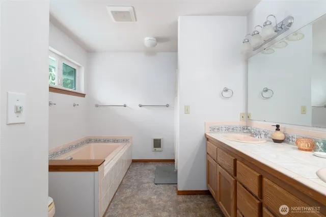 a bathroom with a granite countertop sink and a mirror