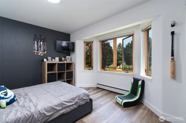 a bedroom with a bed and a window