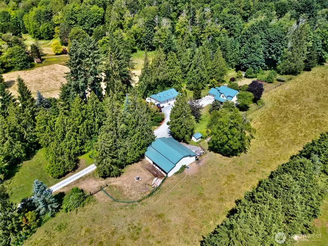 an aerial view of a house with a yard and lake view