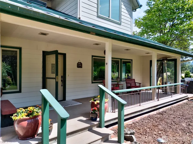 a front view of a house with outdoor seating and plants