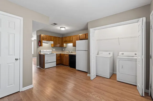 a kitchen with white cabinets and white appliances