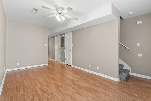 a view of an empty room with wooden floor