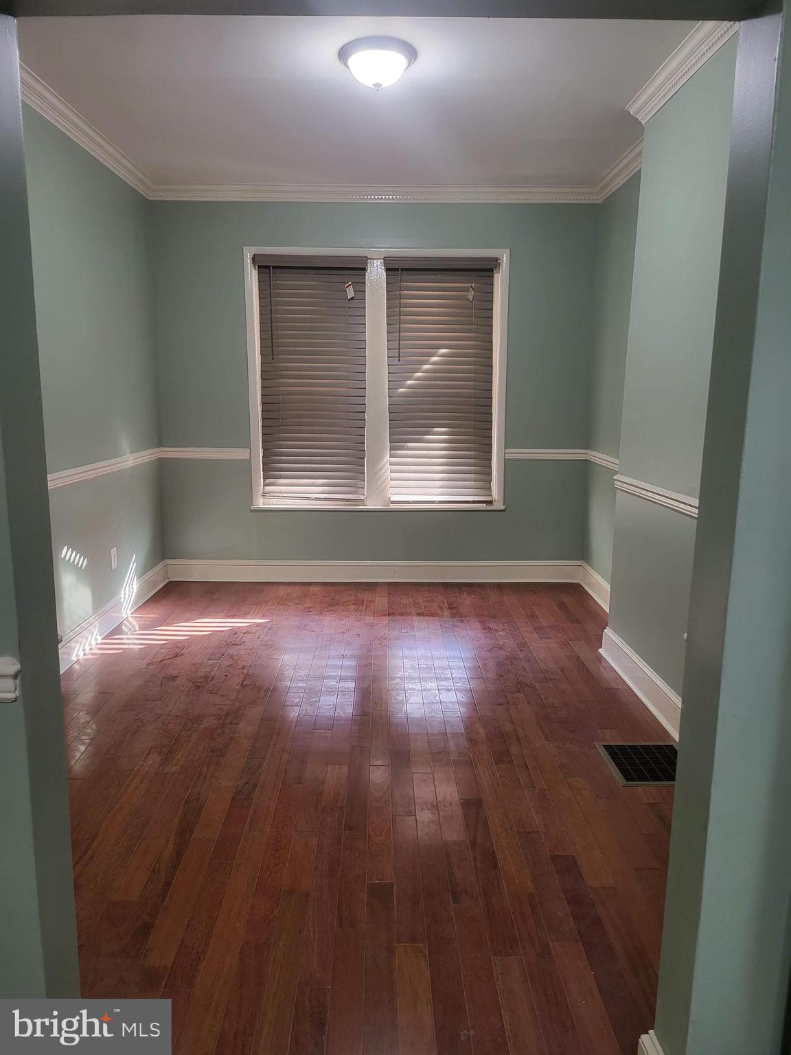 1817 Mifflin Street Philadelphia, PA 19145 - Photo 6 of 16 an empty room with wooden floor and windows