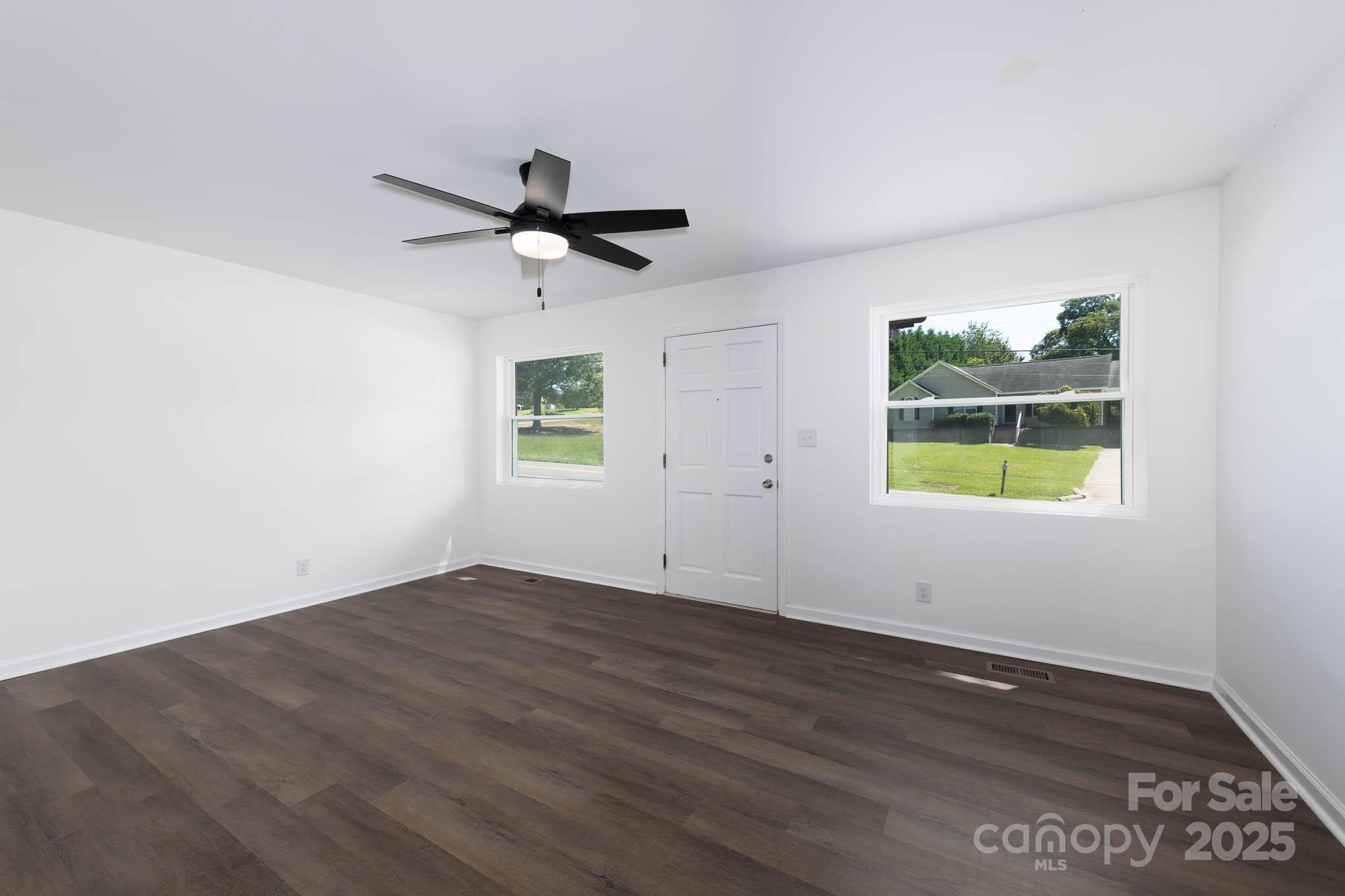 108 South Little Texas Road Kannapolis, NC 28083 - Photo 2 of 24 an empty room with wooden floor and windows
