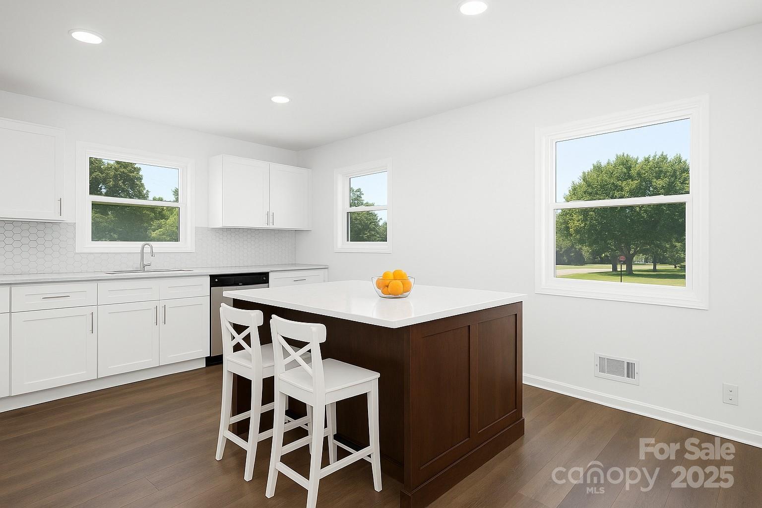 108 South Little Texas Road Kannapolis, NC 28083 - Photo 9 of 24 a kitchen with stainless steel appliances kitchen island a table chairs in it and wooden floors