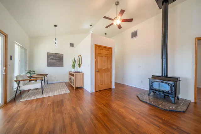 a living room with fireplace furniture and wooden floor