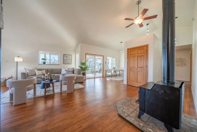 a living room with furniture and wooden floor