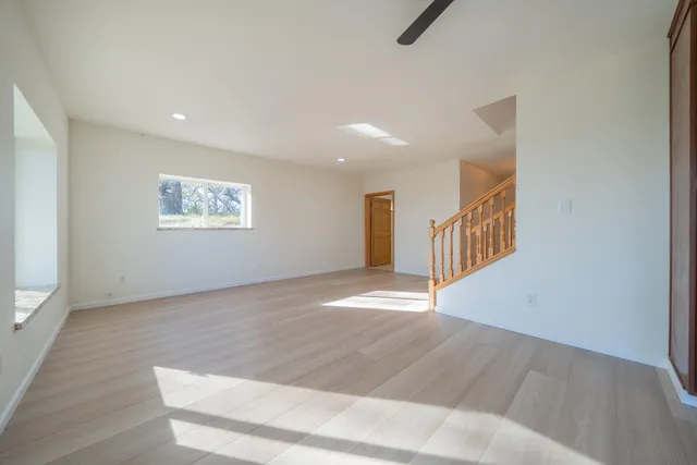 a kitchen with granite countertop wooden cabinets and white appliances