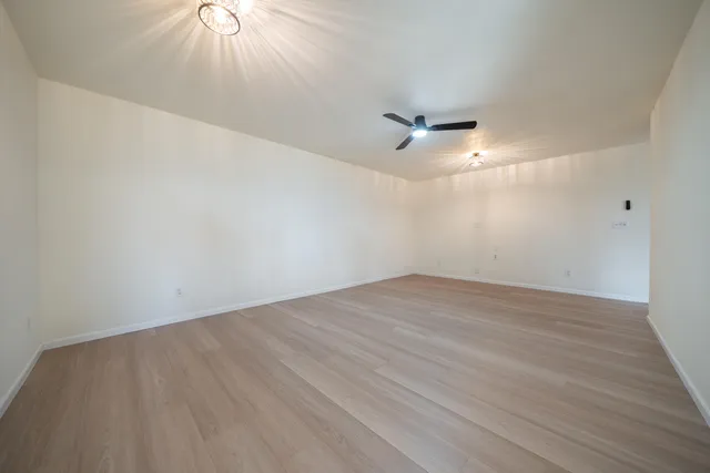 a view of kitchen with granite countertop cabinets and wooden floor