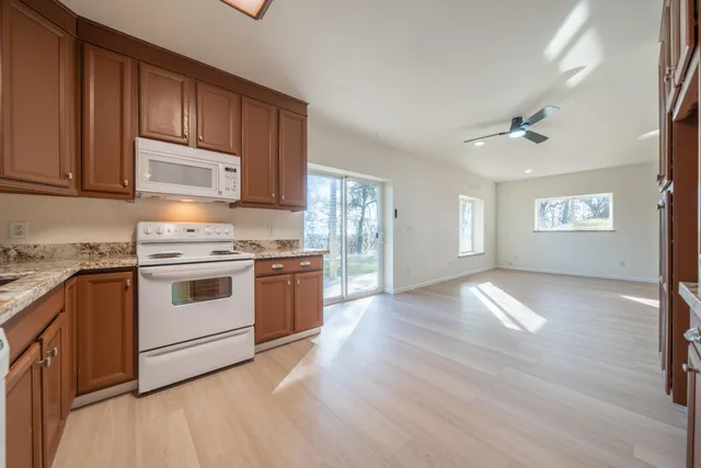 a view of a livingroom with furniture and floor to ceiling window