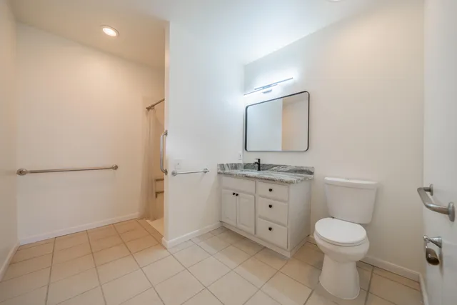 a view of a livingroom with furniture and floor to ceiling window